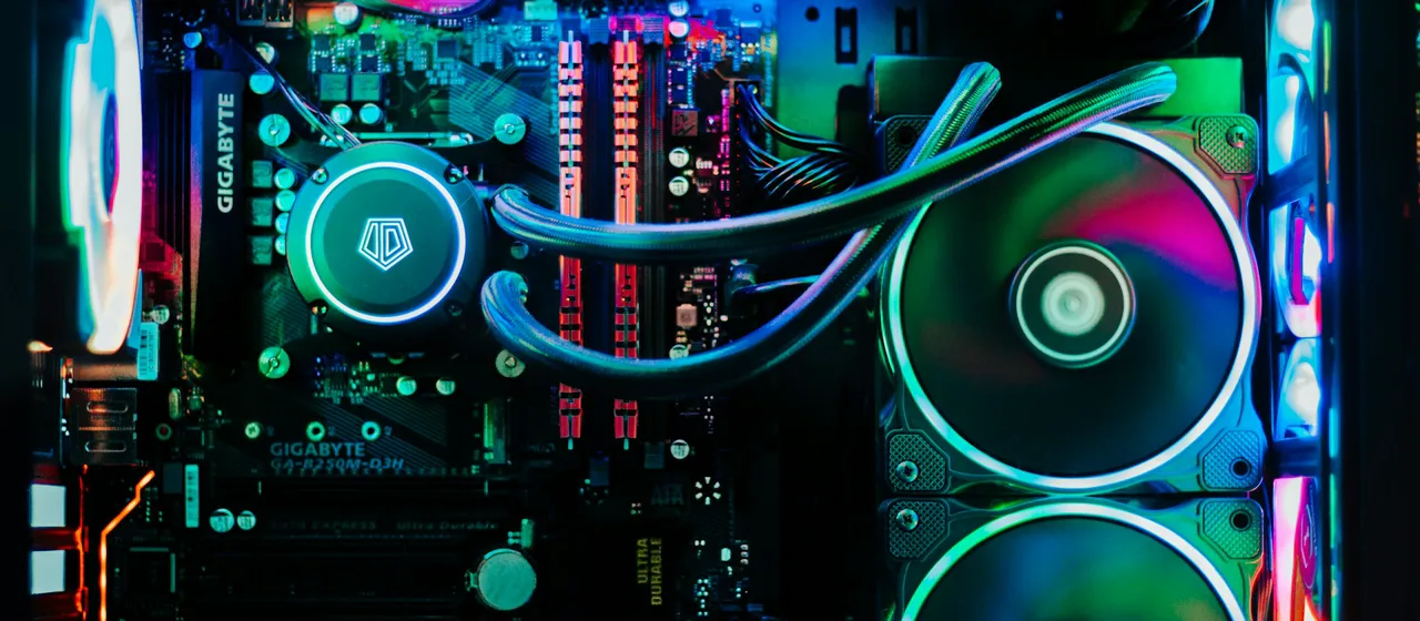 Gaming PC motherboard, memory modules, cooling tubes, and RGB fans