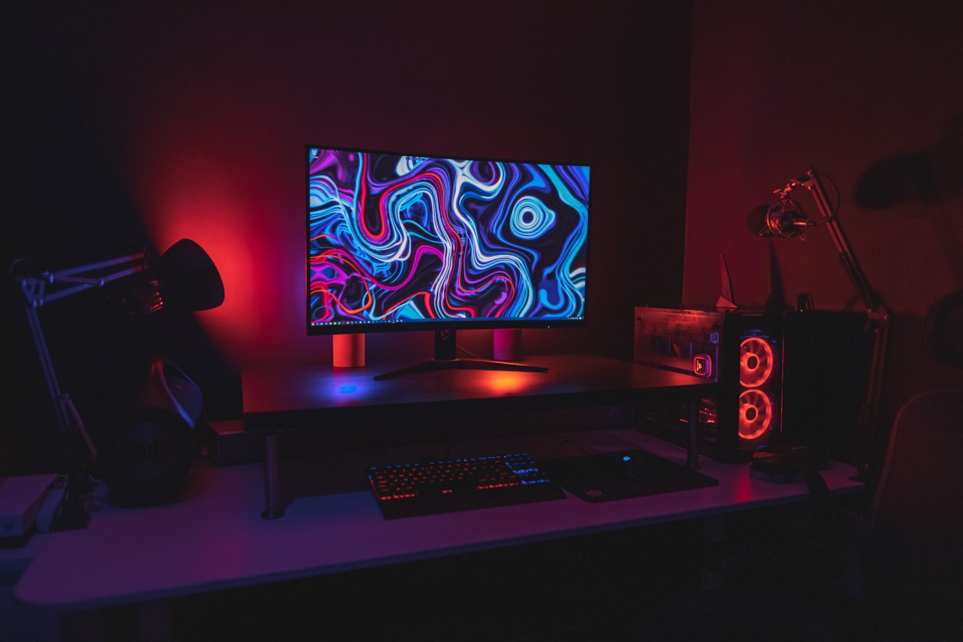 Dark desktop workstation with an illuminated monitor and PC tower